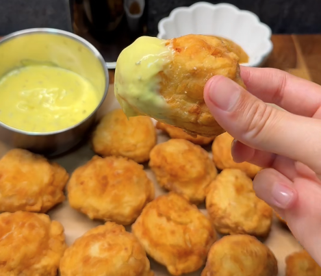 Zelfgemaakte krokante kipnuggets gefrituurd en geserveerd met zoetzure saus en fritessaus
