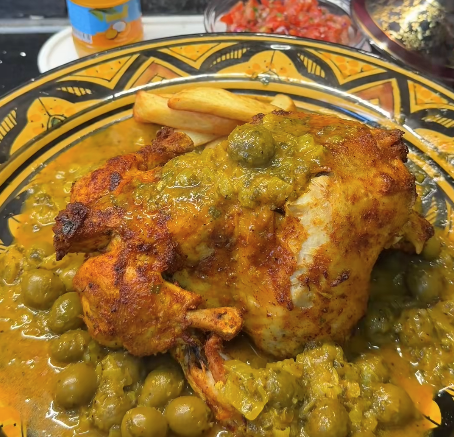 Marokkaanse kip djaj mhamer geroosterd in de oven geserveerd met olijvensaus, frietjes en Marokkaans brood
